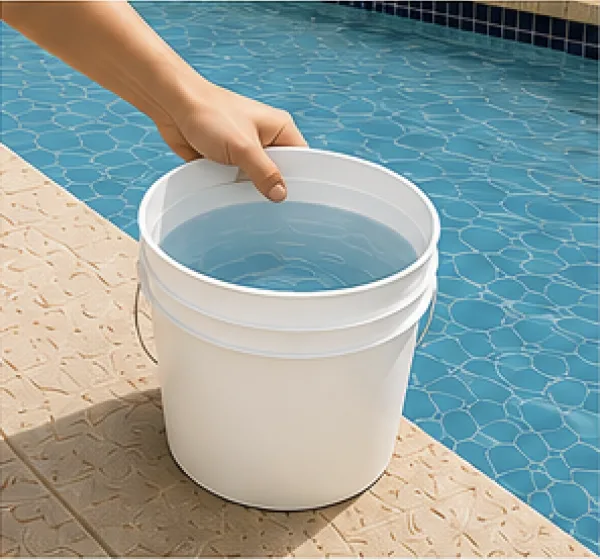Hand filling a 5-gallon bucket with pool water